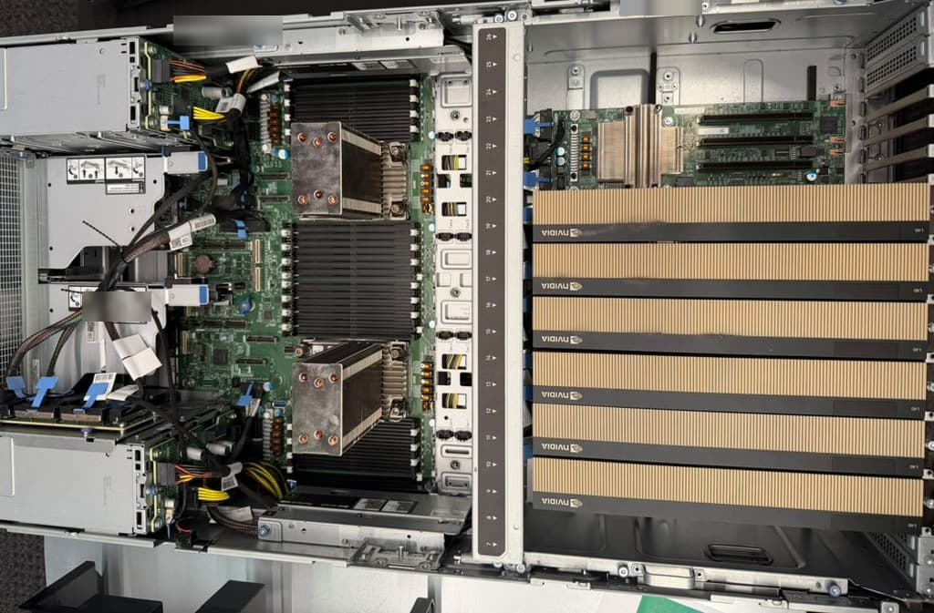 A server seen from above, with six double-width NVIDIA GPUs filling one half of the chassis and two processors in the other.