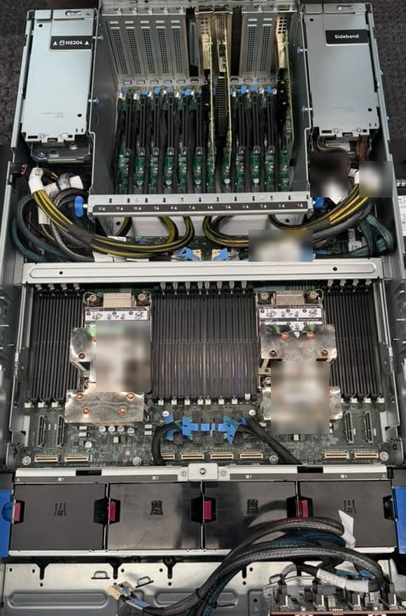 A two-processor server seen from above: a front drive cage, two processor heatsinks each flanked by rows of memory slots, and a row of fans across the middle.